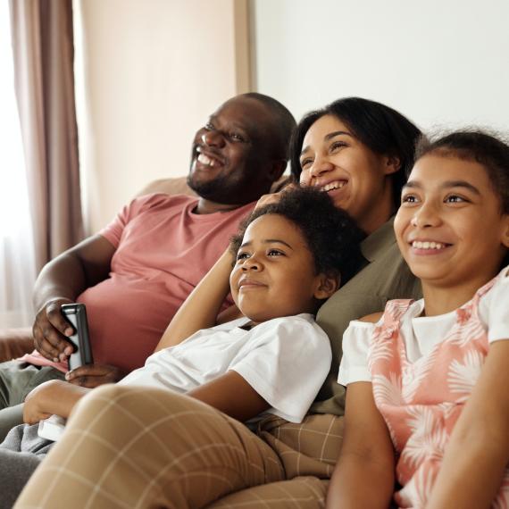 Family watching TV at home