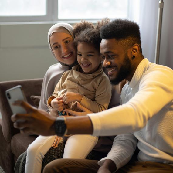 Family taking a selfie in their home