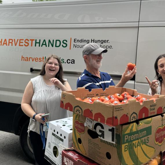 LMCH Staff with Harvest Hands Staff with produce and the harvest hands van